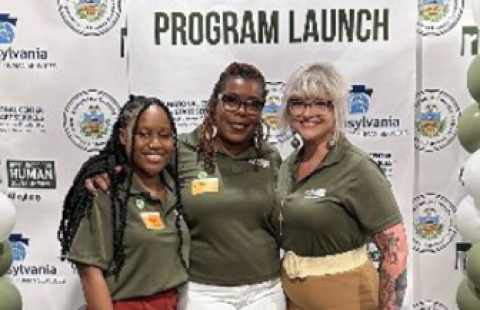 Three smiling women post in front of a backdrop that reads "PA START Allegheny Program Launch."