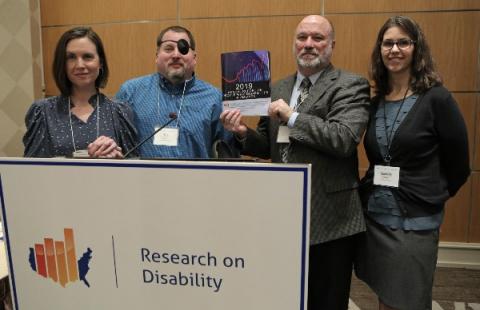 Picture of StatsRRTC staff holding the 2019 Annual Disability Compendium