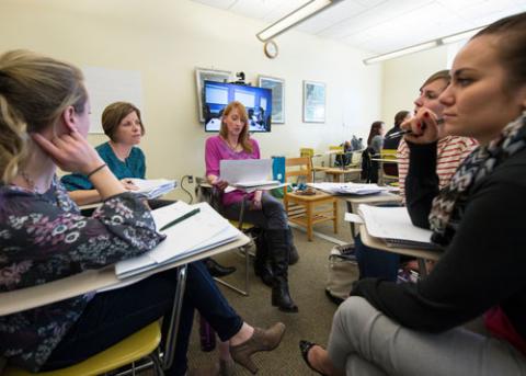 Student Discussion during Breakout Session with distance learners on screen in back