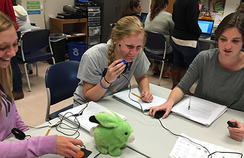 Three students work at an assistive technology training workshop