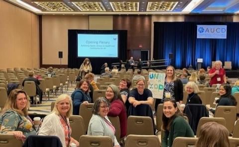 A group photo of NH-ME LEND trainees and staff at the AUCD Conference in Washington, DC. They are sitting in chairs in a ballroom looking backwards at the camera.
