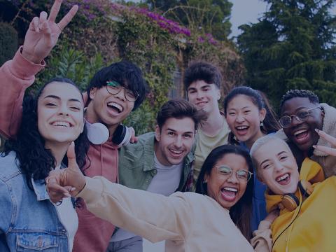 diverse youth pose for a group selfie