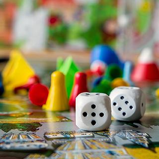 closeup of a board game with dice and colorful game pieces