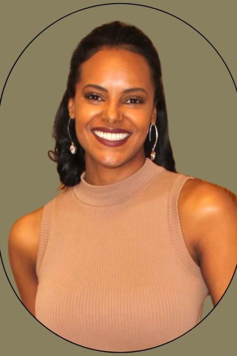 Selam Runyon-Baruch is an African American woman with dark brown shoulder-length hair and brown eyes.