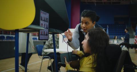 A woman in a wheelchair is voting.