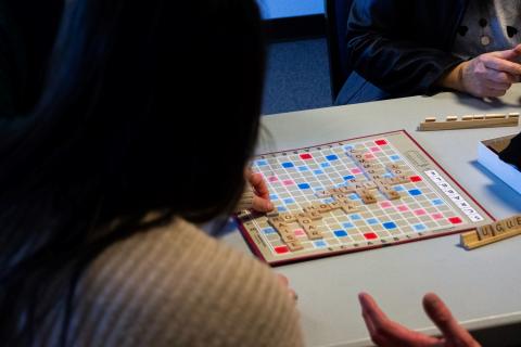 an over the shoulder look at students playing scrabble and chatting
