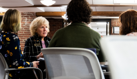 People at a training sit at a table in discussion