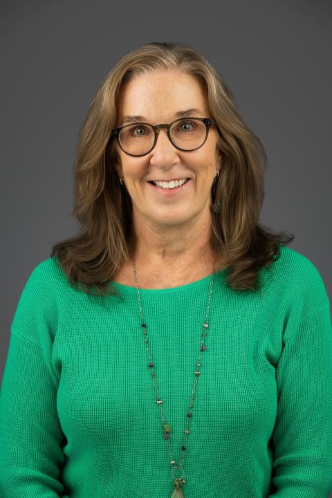 Jill Hinton is a woman with glasses and shoulder length brown hair 
