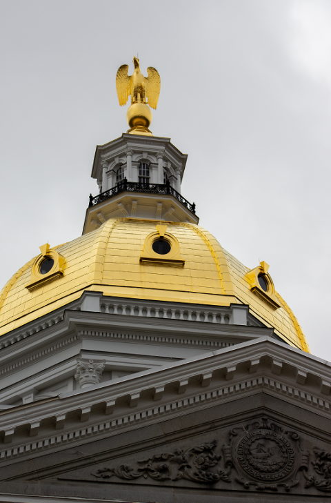 The gold plated spire of the NH Capitol building.