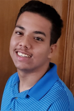 Headshot of Elijah Thomas smiling, with short dark hair, wearing a blue striped polo shirt. 