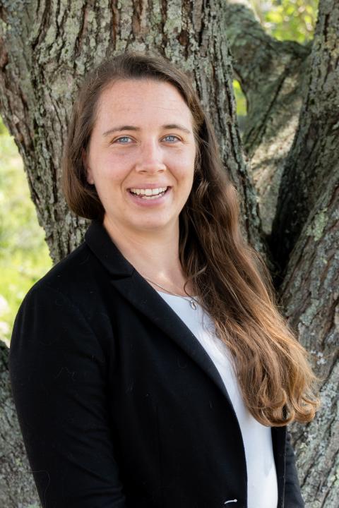 Alyssa is a woman with long brown hair in a professional blazer.
